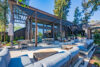 Outdoor patio with gray sectional seating, Contemporary metal pergola providing partial shade