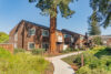 Landscape grounds and pathways through the community at Peartree, mature evergreen tree, blue sky